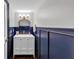 Elegant half-bathroom featuring wainscoting, a vanity, and decorative fixtures at 2 Arpege Nw Way, Atlanta, GA 30327