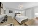 This bedroom features a desk and a bed with a white comforter and a decorative pillow at 2 Arpege Nw Way, Atlanta, GA 30327