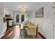 Bright dining room with hardwood floors, a wooden table, and adjacent kitchen at 2 Arpege Nw Way, Atlanta, GA 30327