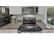 Modern kitchen featuring stainless steel appliances, granite counters, and a stylish stand mixer at 2 Arpege Nw Way, Atlanta, GA 30327