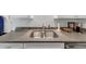 Kitchen featuring stainless steel sink, gray countertops, and modern appliances at 2 Arpege Nw Way, Atlanta, GA 30327