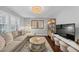 Bright living room with neutral tones, hardwood floors, and stylish furniture at 2 Arpege Nw Way, Atlanta, GA 30327