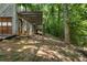Backyard features a covered deck, offering a peaceful outdoor space surrounded by mature trees at 3323 Silver Ridge Ct, Duluth, GA 30096