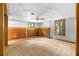 Spacious carpeted basement with natural light from windows and wood paneled accents at 3323 Silver Ridge Ct, Duluth, GA 30096