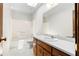 Well-lit bathroom features white tile floors, a vanity, and a shower-tub combo at 3323 Silver Ridge Ct, Duluth, GA 30096