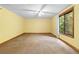 Bright bedroom features neutral carpet, ceiling fan, and a large window with a wooded view at 3323 Silver Ridge Ct, Duluth, GA 30096