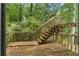 Exterior deck with wooded view and stairs to the yard, great for outdoor enjoyment at 3323 Silver Ridge Ct, Duluth, GA 30096