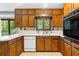 Close up shot of the kitchen, featuring wood cabinets, white countertops, and essential appliances at 3323 Silver Ridge Ct, Duluth, GA 30096