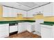 This kitchen is equipped with white cabinets, green countertops, and essential appliances at 3323 Silver Ridge Ct, Duluth, GA 30096