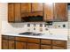 The kitchen features dark wood cabinets, a smooth white countertop and a built-in electric cooktop at 3323 Silver Ridge Ct, Duluth, GA 30096
