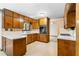 Classic kitchen with abundant wooden cabinetry, white countertops and views to another part of the house at 3323 Silver Ridge Ct, Duluth, GA 30096