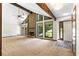 Bright living room boasts a stone fireplace, vaulted ceiling, and large windows offering scenic views at 3323 Silver Ridge Ct, Duluth, GA 30096