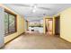 Open-concept living room with access to kitchen, featuring neutral carpet and a sliding glass door at 3323 Silver Ridge Ct, Duluth, GA 30096