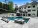 This backyard features an outdoor pool, spa, lounging areas, and a covered patio, perfect for outdoor relaxation and entertainment at 4225 Wieuca Ne Rd, Atlanta, GA 30342