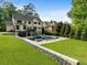 Expansive backyard with an inviting pool, lush lawn and stone accents perfect for outdoor enjoyment at 4225 Wieuca Ne Rd, Atlanta, GA 30342