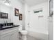 Well-lit bathroom features a tub-shower, granite counters, grey tiled floors, and modern fixtures that create a relaxing space at 4225 Wieuca Ne Rd, Atlanta, GA 30342