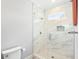 Sleek bathroom featuring a glass enclosed shower with marble tiling and a built-in niche for bath products at 4225 Wieuca Ne Rd, Atlanta, GA 30342