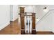 Hallway featuring wood floors, paneled wainscoting, and a wooden staircase at 4225 Wieuca Ne Rd, Atlanta, GA 30342