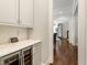 Hallway view features a wine fridge built into the cabinets and hardwood floors at 4225 Wieuca Ne Rd, Atlanta, GA 30342