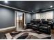 Relax in this home theater featuring tiered seating, a projector, and a large screen for the ultimate cinematic experience at 4225 Wieuca Ne Rd, Atlanta, GA 30342