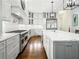 Gourmet kitchen featuring white cabinetry, marble countertops, stainless steel appliances, and a large island at 4225 Wieuca Ne Rd, Atlanta, GA 30342