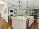 Bright open concept with hardwood floors, white cabinets, stone countertops, stainless appliances and a coffered ceiling at 4225 Wieuca Ne Rd, Atlanta, GA 30342