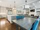 Open kitchen and living area with large island, white cabinets, stainless appliances, fireplace, and hardwood floors at 4225 Wieuca Ne Rd, Atlanta, GA 30342