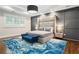 Main bedroom featuring a grey accent wall, high headboard, hardwood floors, and a blue rug at 4225 Wieuca Ne Rd, Atlanta, GA 30342