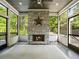 Cozy sunroom with a stone fireplace and multiple windows that bring the outdoors in at 4225 Wieuca Ne Rd, Atlanta, GA 30342