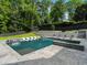 Inviting backyard pool with integrated lounge chairs and a spa, surrounded by lush greenery, ideal for relaxation and recreation at 4225 Wieuca Ne Rd, Atlanta, GA 30342