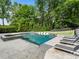 Lush backyard pool, with integrated seating, a hot tub, and plenty of greenery, creating a serene outdoor oasis at 4225 Wieuca Ne Rd, Atlanta, GA 30342