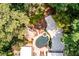 Aerial view showing the home, pool, deck, driveway, and surrounding lush greenery at 4850 Lake Fjord Pass, Marietta, GA 30068