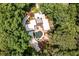 Bird's eye view of the home nestled among mature trees and manicured landscaping at 4850 Lake Fjord Pass, Marietta, GA 30068