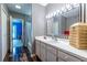 Bathroom with striped wallpaper, an extended vanity, and modern lighting at 4850 Lake Fjord Pass, Marietta, GA 30068