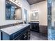 Spacious bathroom featuring dual dark vanities with marble countertops at 4850 Lake Fjord Pass, Marietta, GA 30068
