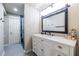 Modern bathroom featuring a white vanity, black hardware, and a glass-enclosed shower with a stylish black marble tile at 4850 Lake Fjord Pass, Marietta, GA 30068