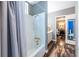 Bathroom with a shower/tub combo and an open doorway leading to another room at 4850 Lake Fjord Pass, Marietta, GA 30068