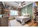 Unique bedroom with custom shoe display, leafy wall decor, ceiling fan, and natural light, offering a distinctive style at 4850 Lake Fjord Pass, Marietta, GA 30068