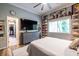 Stylish bedroom with decorative art, closet access, gray color palette, and ceiling fan providing a modern and comfortable feel at 4850 Lake Fjord Pass, Marietta, GA 30068