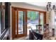 Dining room with wooden table set near sliding glass doors and windows offering scenic outdoor views at 4850 Lake Fjord Pass, Marietta, GA 30068