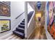 Bright hallway with a carpeted staircase, artistic decor, and hardwood floors, creating a welcoming and visually appealing entrance at 4850 Lake Fjord Pass, Marietta, GA 30068