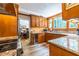 Well-lit kitchen with modern appliances, wooden cabinets, granite countertops and view to dining room at 4850 Lake Fjord Pass, Marietta, GA 30068
