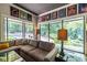Bright living room features a comfortable sectional sofa, large windows with wooded views and stylish decor at 4850 Lake Fjord Pass, Marietta, GA 30068