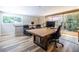 Well-lit office space with a large desk, comfortable seating, and a view of the surrounding greenery, promoting productivity at 4850 Lake Fjord Pass, Marietta, GA 30068