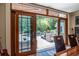 View of the pool from indoors showcasing the outdoor entertainment area and lush landscape through sliding glass doors at 4850 Lake Fjord Pass, Marietta, GA 30068