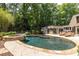 Inviting backyard pool with attached spa, surrounded by lush greenery and a patio perfect for relaxation and entertaining at 4850 Lake Fjord Pass, Marietta, GA 30068