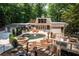 Home's backyard featuring a pool, hot tub, multi-level deck, patio, and lush landscaping at 4850 Lake Fjord Pass, Marietta, GA 30068