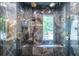 Luxury shower with black and grey marble and multiple shower heads at 4850 Lake Fjord Pass, Marietta, GA 30068
