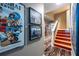 Eclectic staircase features vibrant art, and contrasting floorings, adding a splash of color and personality to the home at 4850 Lake Fjord Pass, Marietta, GA 30068