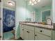 Well-lit bathroom featuring a shower with curtain and a sleek vanity with ample counter space at 549 Greenridge Ln, Loganville, GA 30052